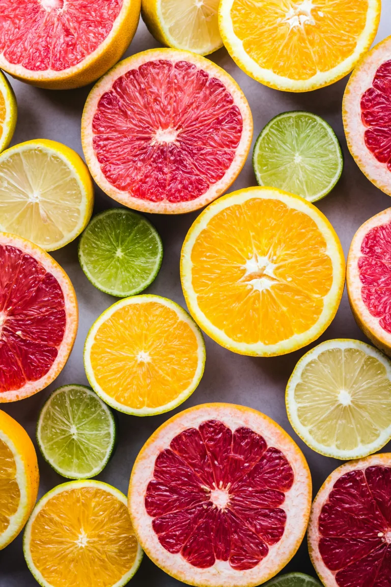 A variety of cut oranges, lemons, grapefruits, and limes that provide vitamin c.
